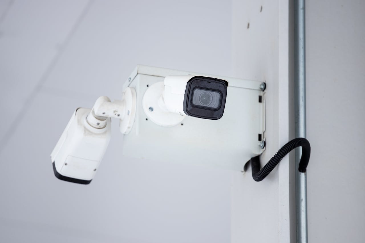 A close-up shot of a modern, mounted surveillance camera highlighting security and surveillance.
